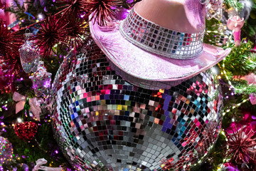Christmas background with a disco ball and festive garland lights, selective focus. Concept for a Christmas party