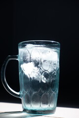 glass of water with ice on a black background