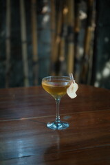 Elegant cocktail with apple garnish on wooden table, perfect for bar menus, social media posts, and lifestyle branding