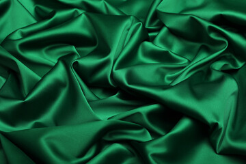 Close-up of luxurious dark green acetate satin fabric, heavily draped and folded to showcase its silky texture, rich luster, and flowing nature, ideal for fashion and elegant apparel design.