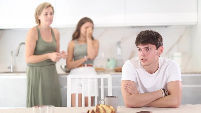 Upset guy dont speaking after discord with mother and young wife standing behind