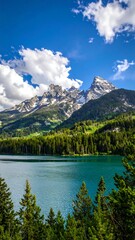 Serene mountain range reflecting in a calm, turquoise lake under a sunny sky