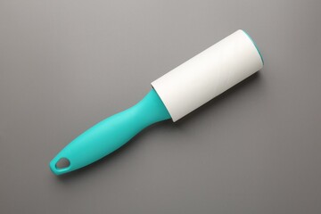 One lint roller on grey background, top view
