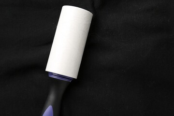 Sticky lint roller on black shirt, top view