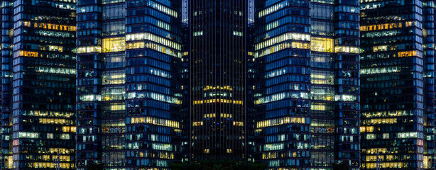 Multi-stories office building at night with worker working overtime. late night at office. lighting and working people within