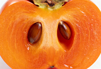 Juicy Persimmon Half with Seeds on White Background(generated by AI)