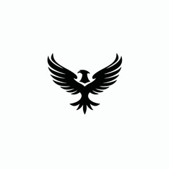 Obraz premium Majestic black eagle or phoenix silhouette icon with wings spread, symbolizing power, freedom, and strength. Vector graphic design element.