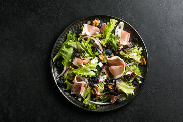 Salad with prosciutto, feta, herbs, nuts and red onion