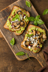 Avocado toast with sautéed mushrooms on rustic bread