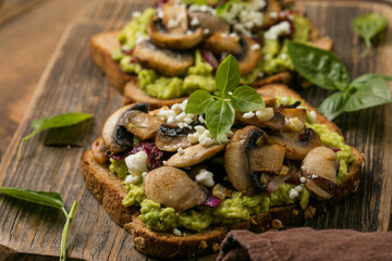 Avocado toast with sautéed mushrooms on rustic bread