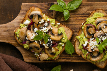 Avocado toast with sautéed mushrooms on rustic bread