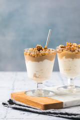 Apple caramel parfait with nuts in glass cups