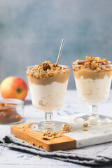 Apple caramel parfait with nuts in glass cups