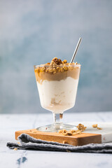 Apple caramel parfait with nuts in glass cups