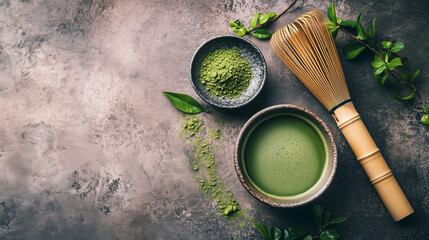 Matcha tea set in traditional style with green leaves on stone background