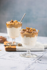 Apple caramel parfait with nuts in glass cups