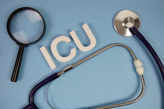 ICU abbreviation of Intensive Care Unit alphabet letters with magnifying glass and stethoscope on blue background