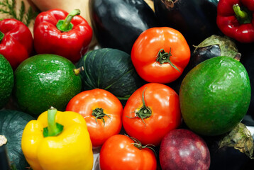 Composition with assorted raw organic vegetables (Small japanese pumpkin, Avocado, Bell peppers, Tomatoes). Detox diet. Top view.