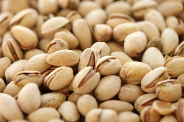 Tasty unpeeled pistachios as background, top view flat lay background