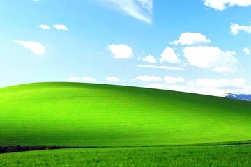 Obraz premium Serene Rolling Hills Landscape Lush Green Grass, Blue Sky, Peaceful Tranquility, Perfect for Relaxation and Rest