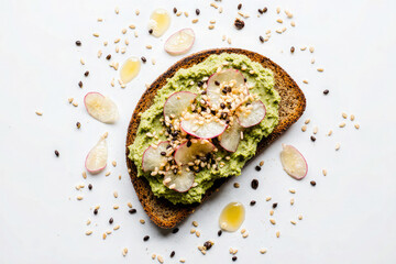 A slice of whole grain bread topped with mashed avocado, sliced radishes, and sprinkled with sesame seeds. The background is plain white.