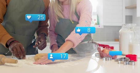 couple mixing and kneading dough on marble countertop sparking social media likes hearts comments - Powered by Adobe