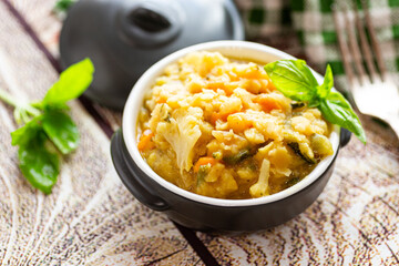 Warm vegetable pea porridge with fresh herbs