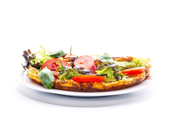 Fluffy omelette with lettuce and tomatoes on a white plate