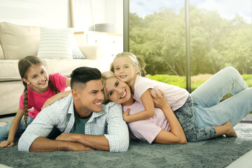 Happy family with children on floor at home