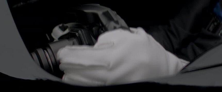 Close-up of a race car driver in a driving fast on a racing track, evening race