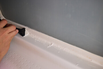 The process of applying sealant during a bathroom renovation involves multiple technical steps