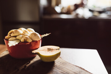 Honey mushrooms with bay leaves and quince on a rustic wooden table