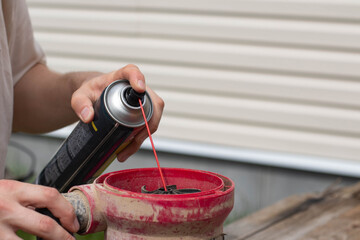 Drainage pump. A man is lubricating a drainage pump with oil.