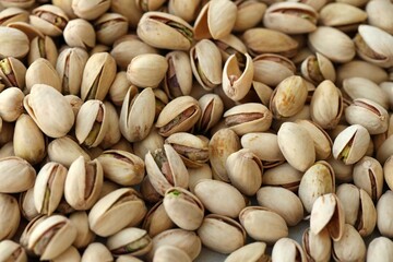 Many tasty unpeeled pistachios top view flat lay background pattern