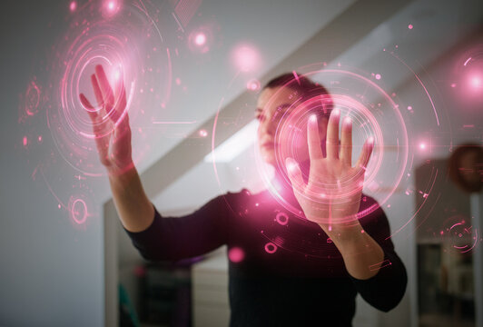 Woman using immersive touch interface with futuristic virtual display