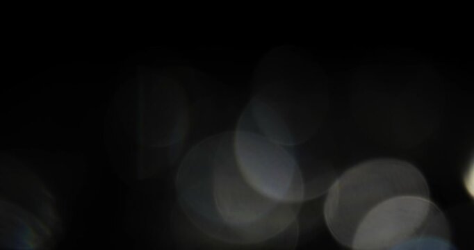 Bokeh light FX on dark background. Can be used as overlay element or background for design projects.  Video in loop.