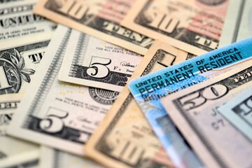 American US dollars money bills with permanent resident green card diversity visa close up
