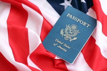 United States passport book on US flag close up. Travel document on official banner photo