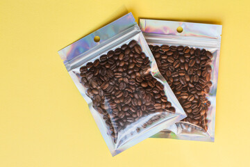 Blank craft plastic pouch mock up with coffee beans inside, transparent pack on studio background with shadow, mylar bag isolated for coffee product