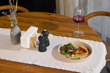 An Elegant Dining Table Setup featuring a Gourmet Meal alongside a fine bottle of Wine