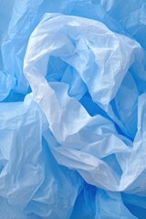 Fototapeta premium Abstract close up of crumpled light blue plastic bags creates a textured background studio shot