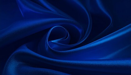 Obraz premium An elegant, close-up shot displaying rich, blue fabric artfully swirled. The cloth is smooth and reflects light, suggesting luxuriousness