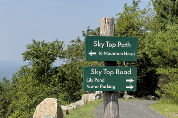 sky top path sign in mohonk preserve with view of lake hiking trail mountain hotel house hike marker path arrow shawangunk mountains ridge gunks new paltz skytop road lily pond valley parking
