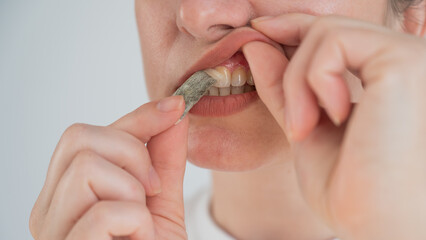 A woman uses chewing tobacco. 