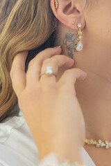 Woman putting on luxury jewelry, elegant accessories and fashion concept, stylish adornment for sophisticated lifestyle