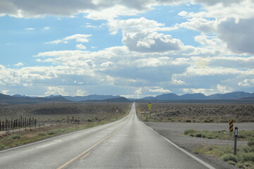 Open straight deserted road near Rachel and Alamo in Nevada desert, USA