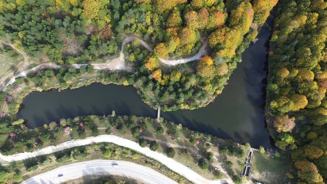 The colors of the tree leaves in the mountains in autumn and the winding, dangerous road. 