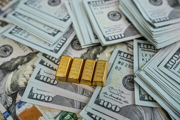 Financial concept with gold bars and US dollars, symbol of success, capital wealth and money growth