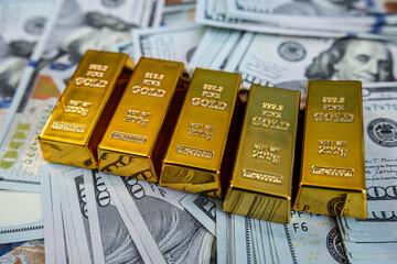 Financial concept with gold bars and US dollars, symbol of success, capital wealth and money growth