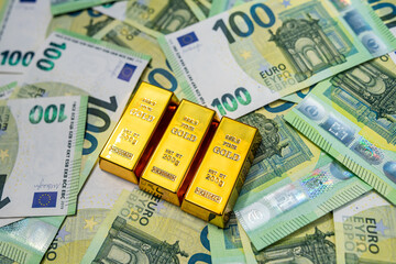 Gold bars on euro banknotes, wealth, finance, investment and business success concept
